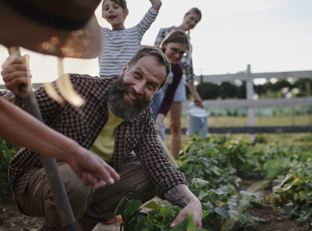 A group of young people, grape pickers, family and the founder of the vineyard celebrating the end of the picking.