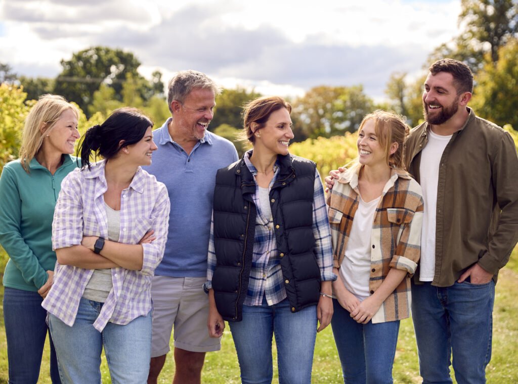 A group of young people, grape pickers, family and the founder of the vineyard celebrating the end of the picking.